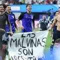 Jugadores de la selección Argentina izan una bandera de defensa por Las Malvinas en celebración por el triunfo contra Inglaterra en las semifinales