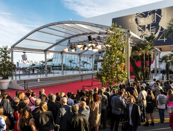 Great Auditorium of the exit door at Cannes in France, the famous red carpeted stairs and crowd of people waiting at the gate output.