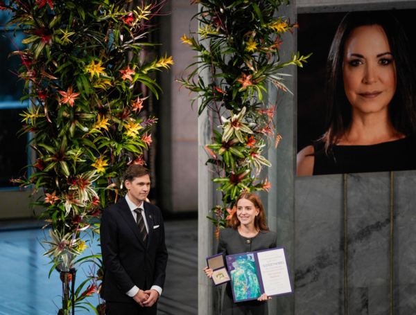 The Norwegian Venezuelan Justice Alliance is organizing a torchlight procession in honor of Nobel Peace Prize laureate Maria Corina Machado in Oslo, Norway, on December 10, 2025. The daughter of the Nobel Peace Prize laureate, Ana Corina Sosa, accepted the award on behalf of her mother during a ceremony at Oslo City Hall. Venezuelan opposition leader Maria Corina Machado received the award for her tireless work to secure democratic rights for the people of Venezuela, and for her fight for a just and peaceful transition from dictatorship to popular rule. Due to the circumstances in her home country of Venezuela, the Nobel Peace Prize laureate was unable to attend the award ceremony in Norway. (Photo by Amanda Pedersen Giske / NTB / AFP) / Norway OUT