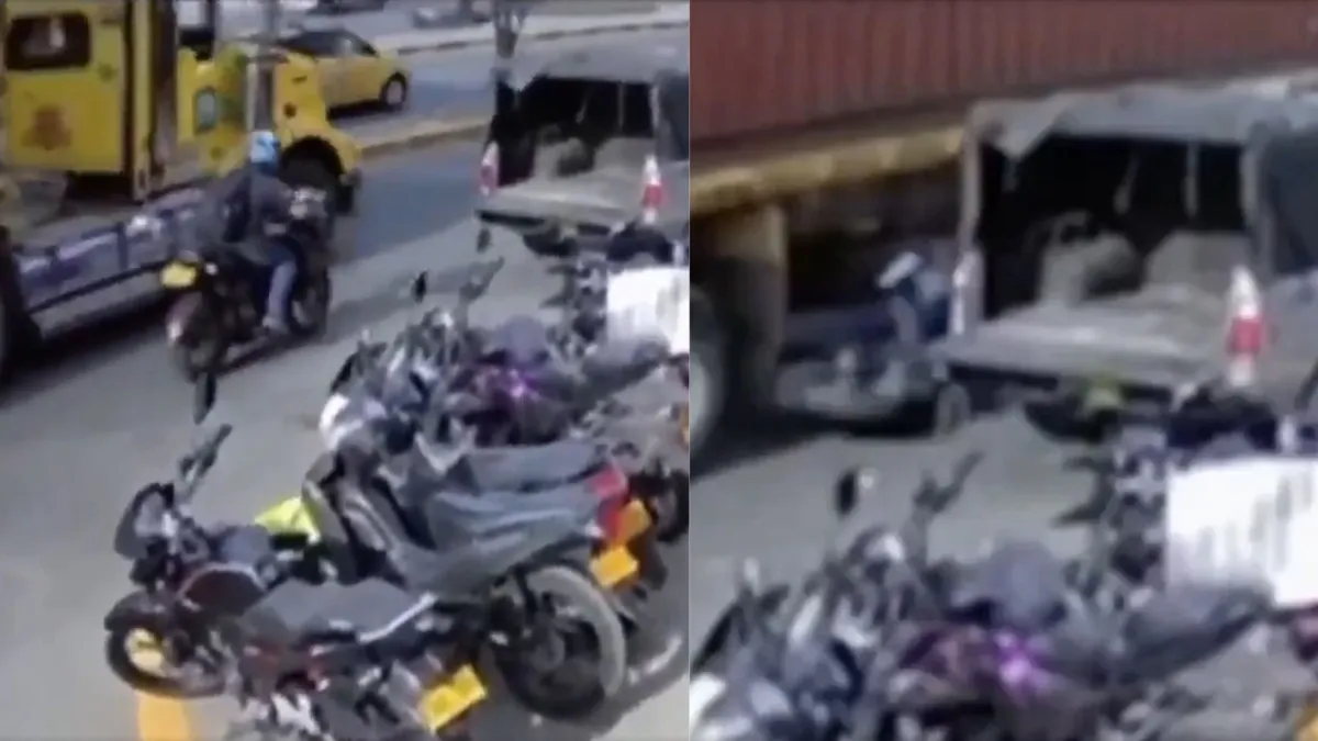Momento exacto en que un motociclista cayó al intentar pasar entre un tractocamión y un carro estacionado en Cali: quedó cerca de las llantas