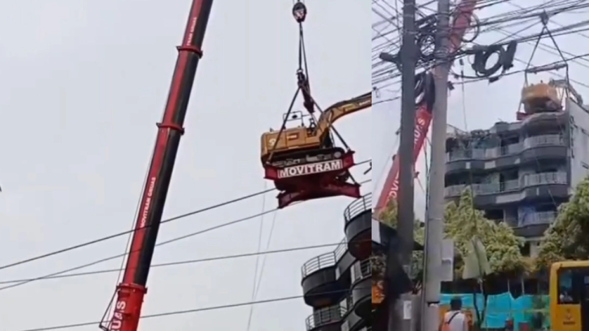 Grúa de construcción subió una retroexcavadora hasta un edificio en Dosquebradas para trabajos de demolición