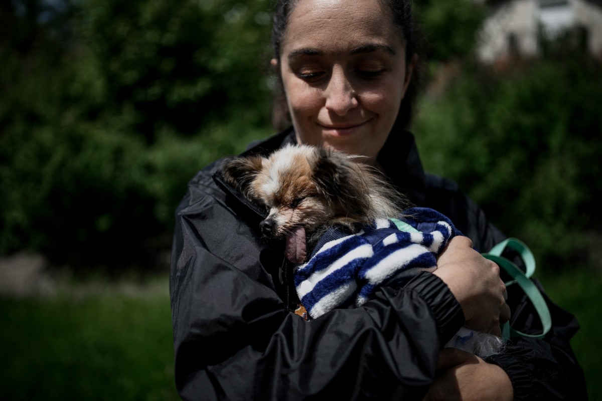 La francesa Ophelie Boudol sostiene a Lazare, un cruce de Spaniel Toy Continental y Papillon, considerado el perro más viejo del mundo.
