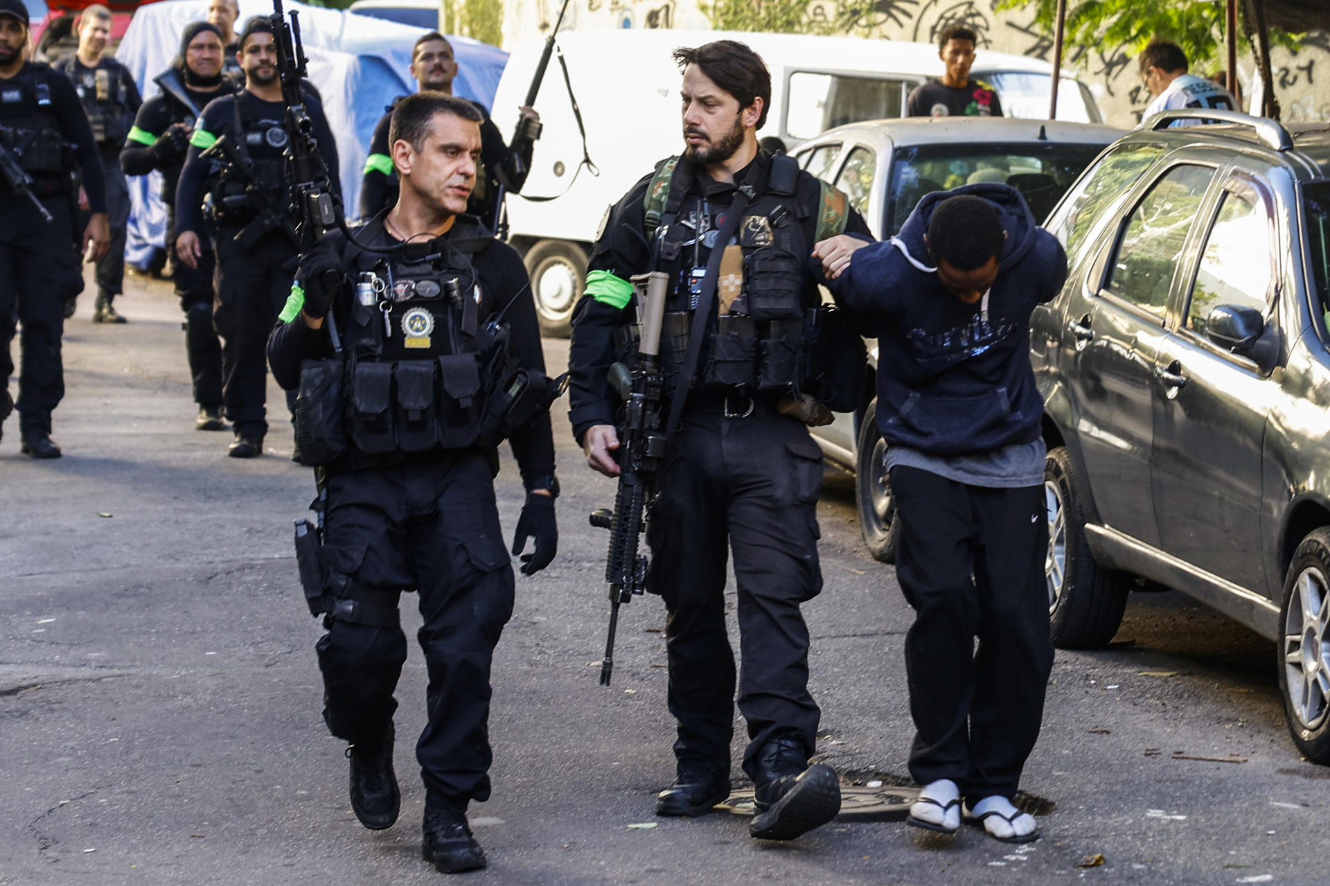 Rio de Janeiro Civil Police guards a person detained in the Santa Marta favela, Brazil